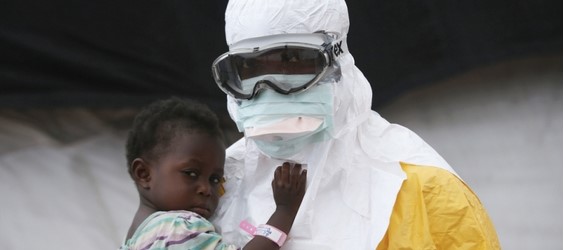 An MSF health worker in protective clothing holds a child suspected of having Ebola in the MSF treatment center in Paynesville, Liberia, October 2014. From (Doctors without borders)